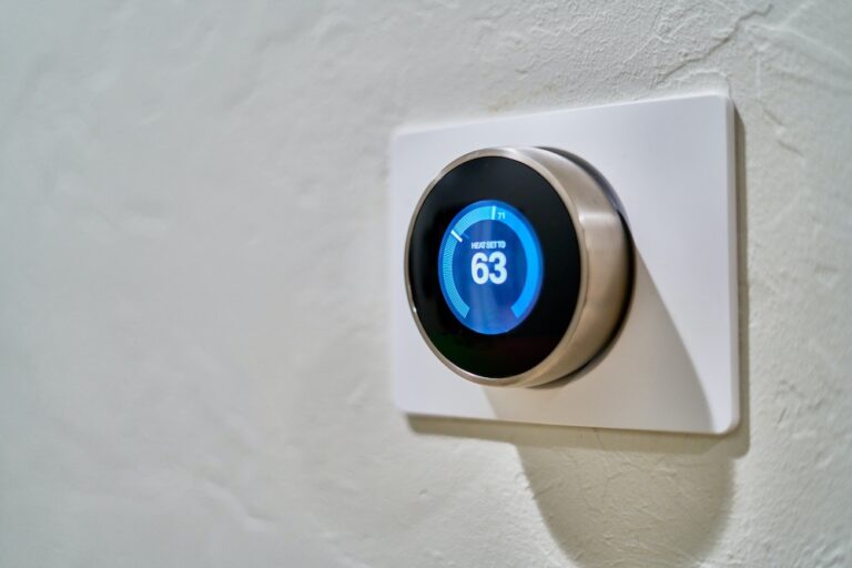 Gray Nest Thermostat Displaying Heat Set to 63
