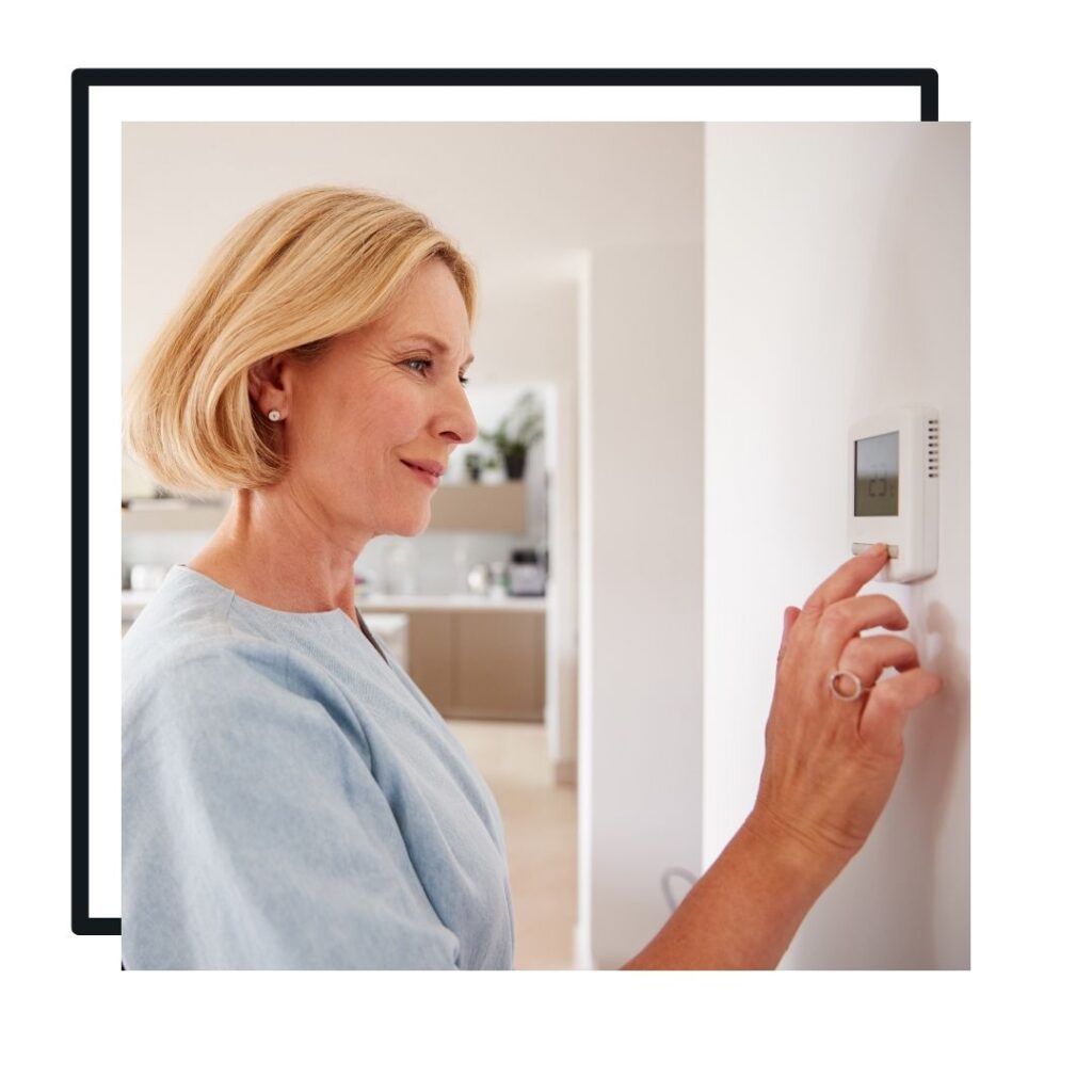 someone changing a thermostat